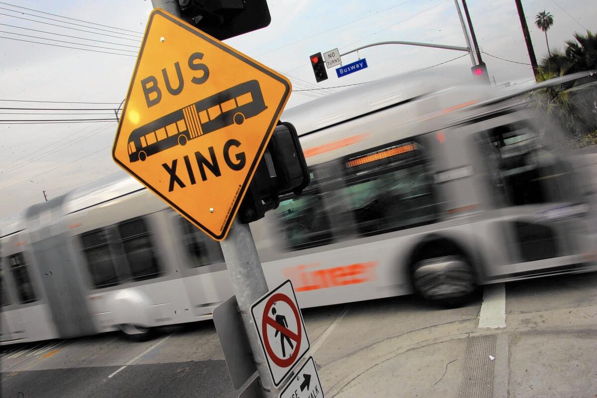 A Metro Orange Line bus travels across Kester Avenue in Van Nuys.
