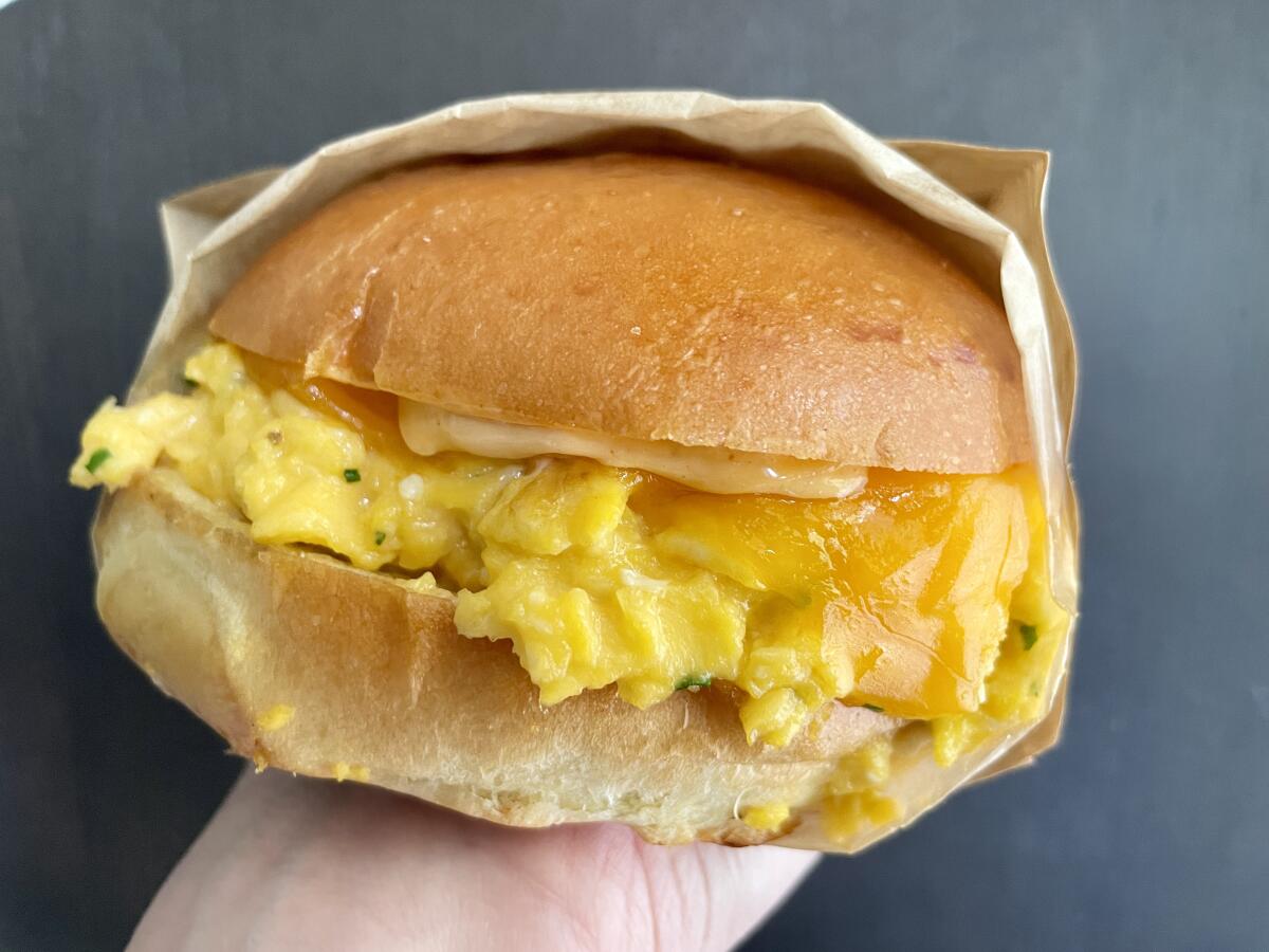 A paper-wrapped bun filled with scrambled eggs