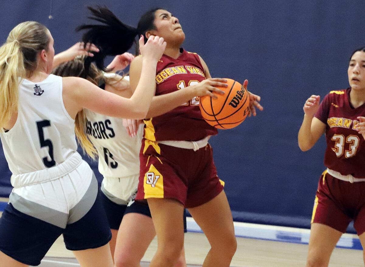 Ocean View's Katelyn Solis (12) drives to the basket against Newport Harbor in the Pacifica Mariner Mayhem Tournament.