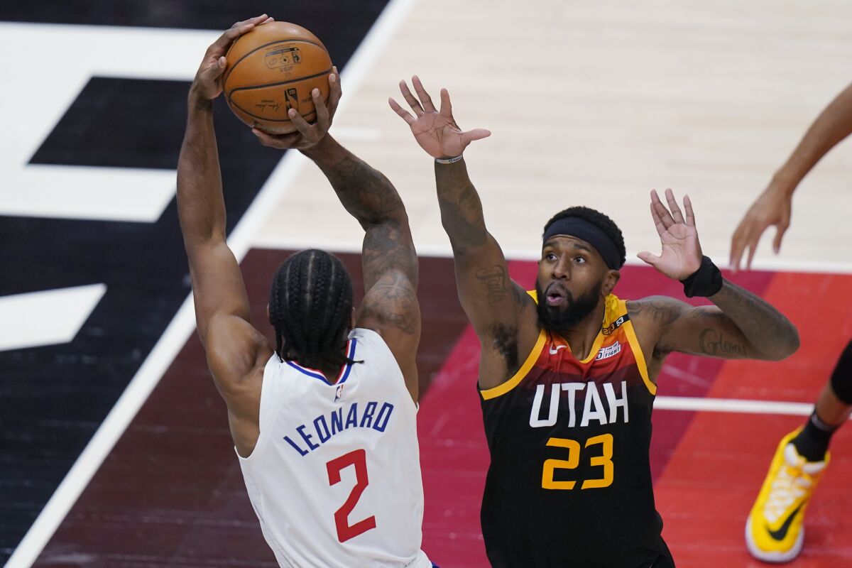 Clippers forward Kawhi Leonard shoots over Utah Jazz forward Royce O'Neale.