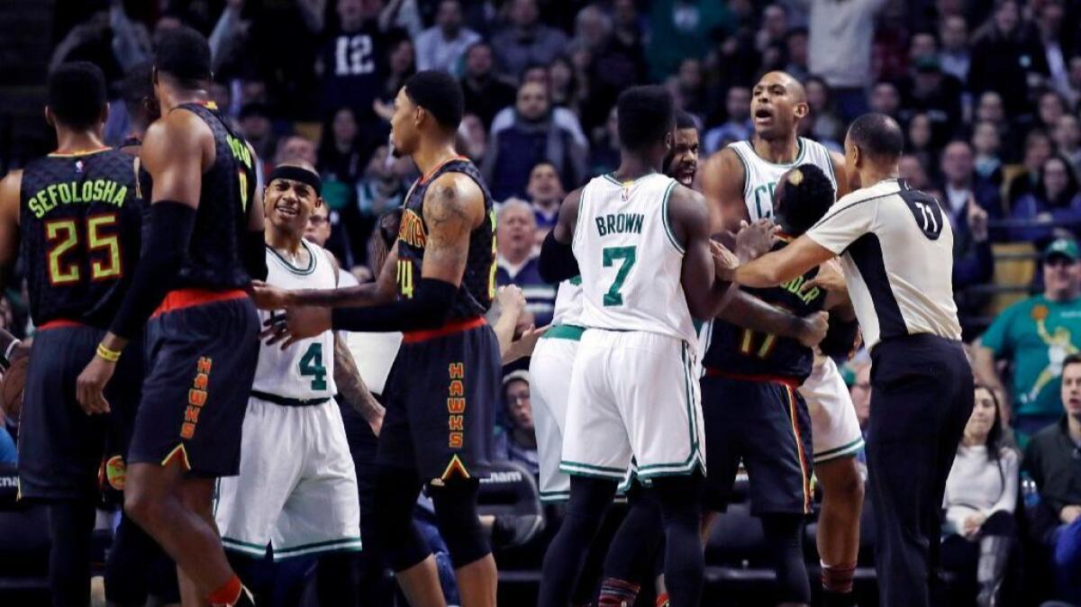 Celtics center Al Horford, right, is held back after being fouled by Hawks center Dwight Howard, second from left, during the second half on Feb. 27.