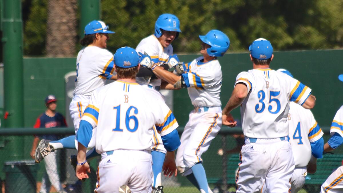 UCLA's bench runs to celebrate with Ty Moore, third from left, after his walk-off hit to beat Gonzaga on May 3.