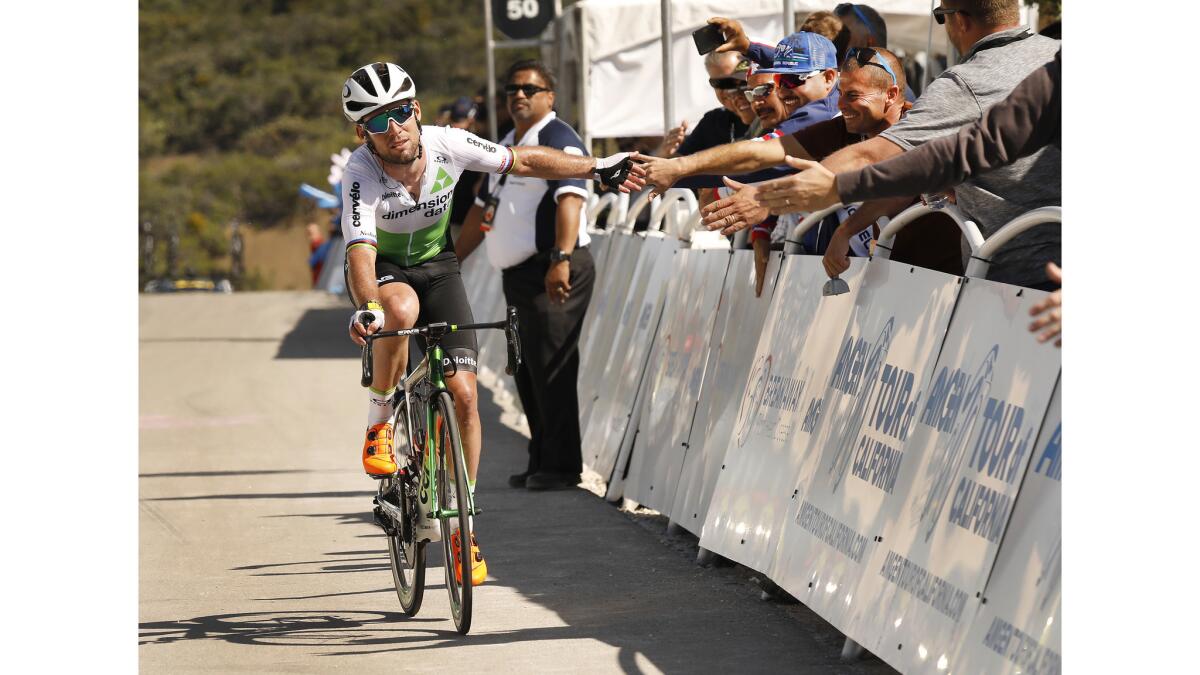 World Champion Mark Cavendish with Team Dimension Data slaps hands with fans as he nears the finish line at the top of Gibraltar Road at East Camino Cielo above Santa Barbara ending Stage 2 of the 2018 Amgen Tour of California.