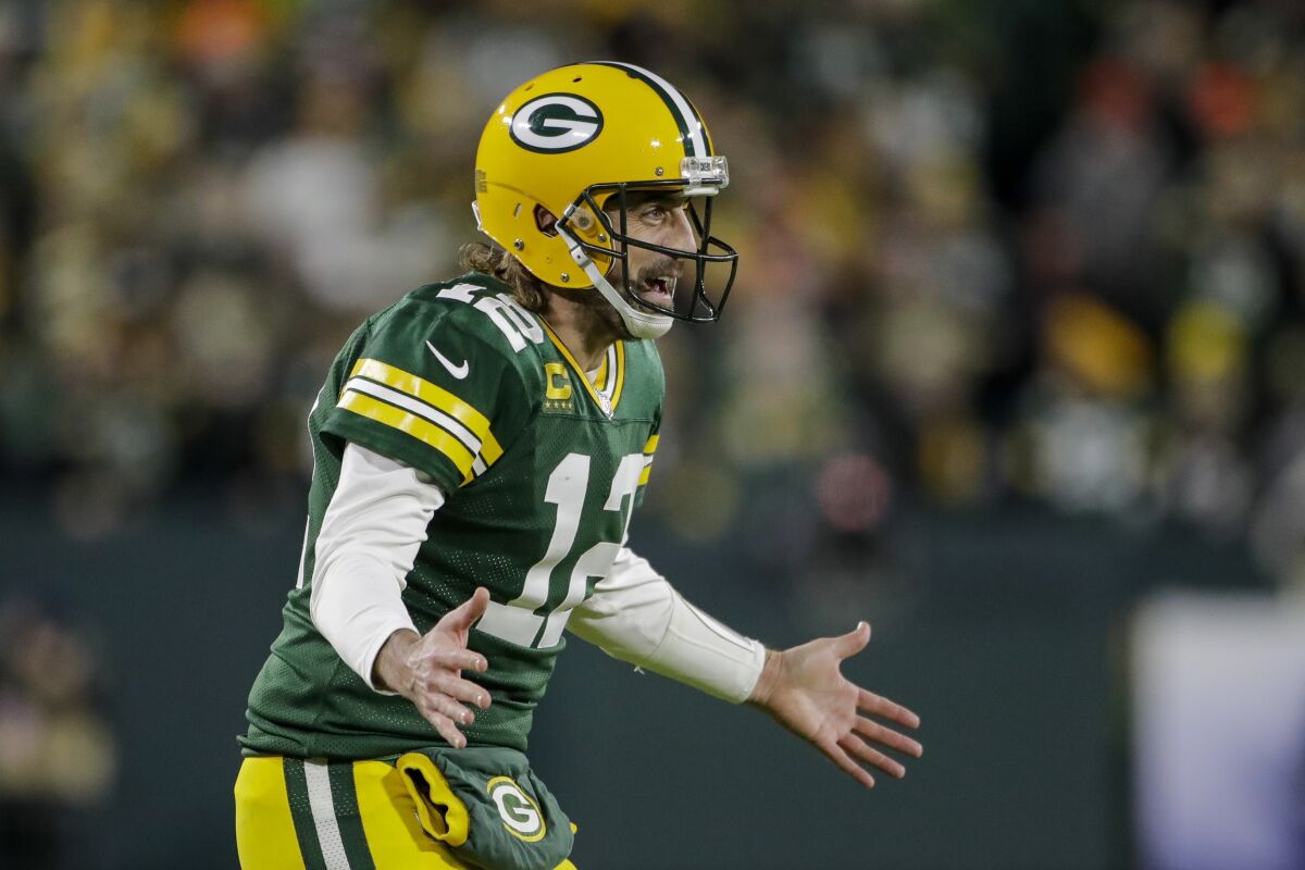 Green Bay Packers' Aaron Rodgers celebrates an Aaron Jones' touchdown run during the second half of an NFL football game against the Chicago Bears Sunday, Dec. 12, 2021, in Green Bay, Wis. (AP Photo/Aaron Gash)