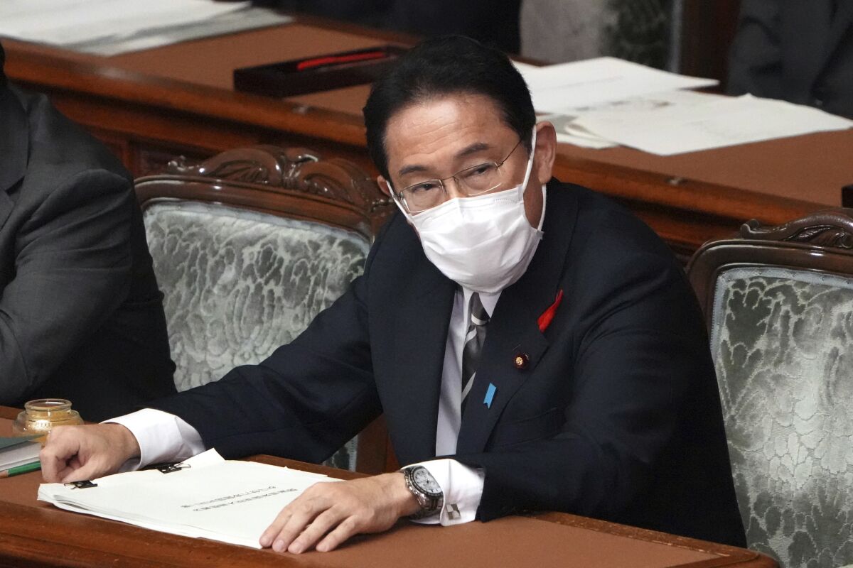 Japanese Prime Minister Fumio Kishida prepares to deliver his first policy speech during an extraordinary Diet session at the lower house of parliament Friday, Oct. 8, 2021, in Tokyo. (AP Photo/Eugene Hoshiko)