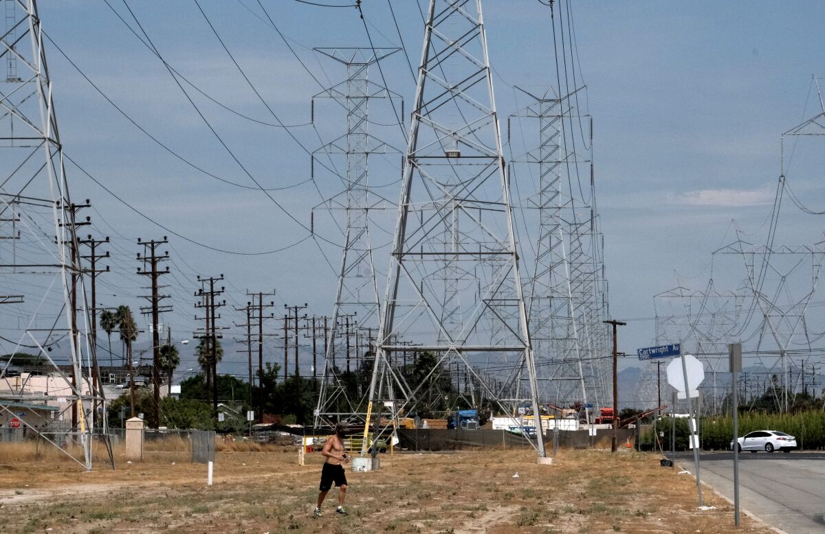 A jogger runs in extreme heat Saturday in North Hollywood.