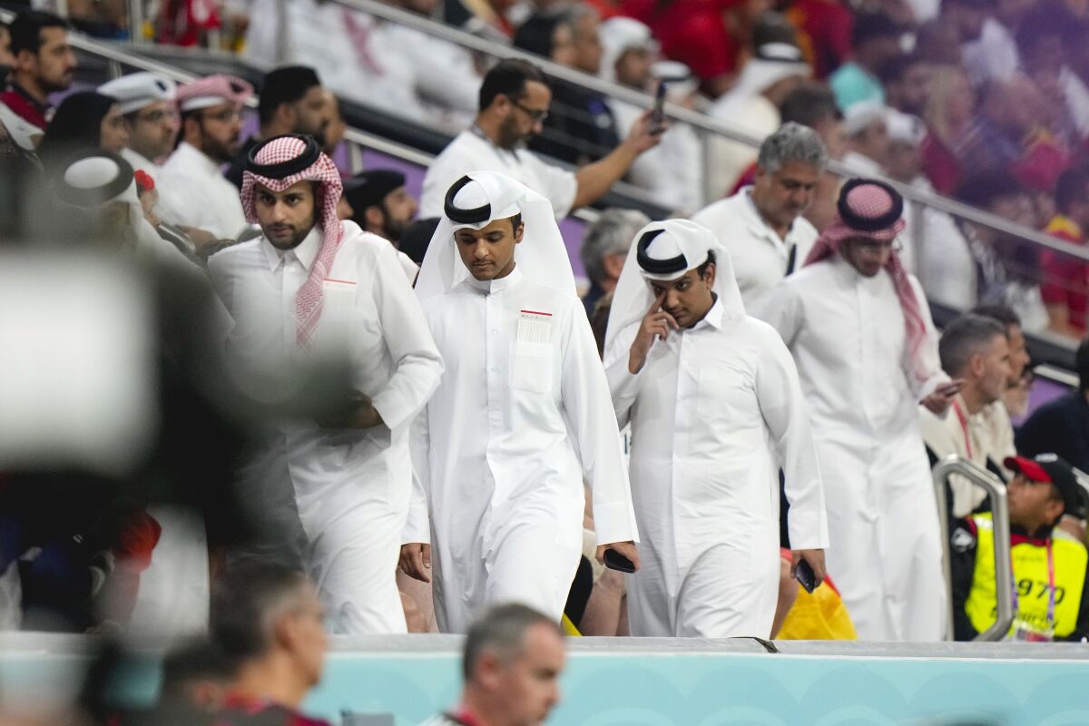 Spectators leave the stands before the end of the second half of the World Cup group E soccer match between Spain and Germany, at the Al Bayt Stadium in Al Khor , Qatar, Sunday, Nov. 27, 2022. (AP Photo/Luca Bruno)