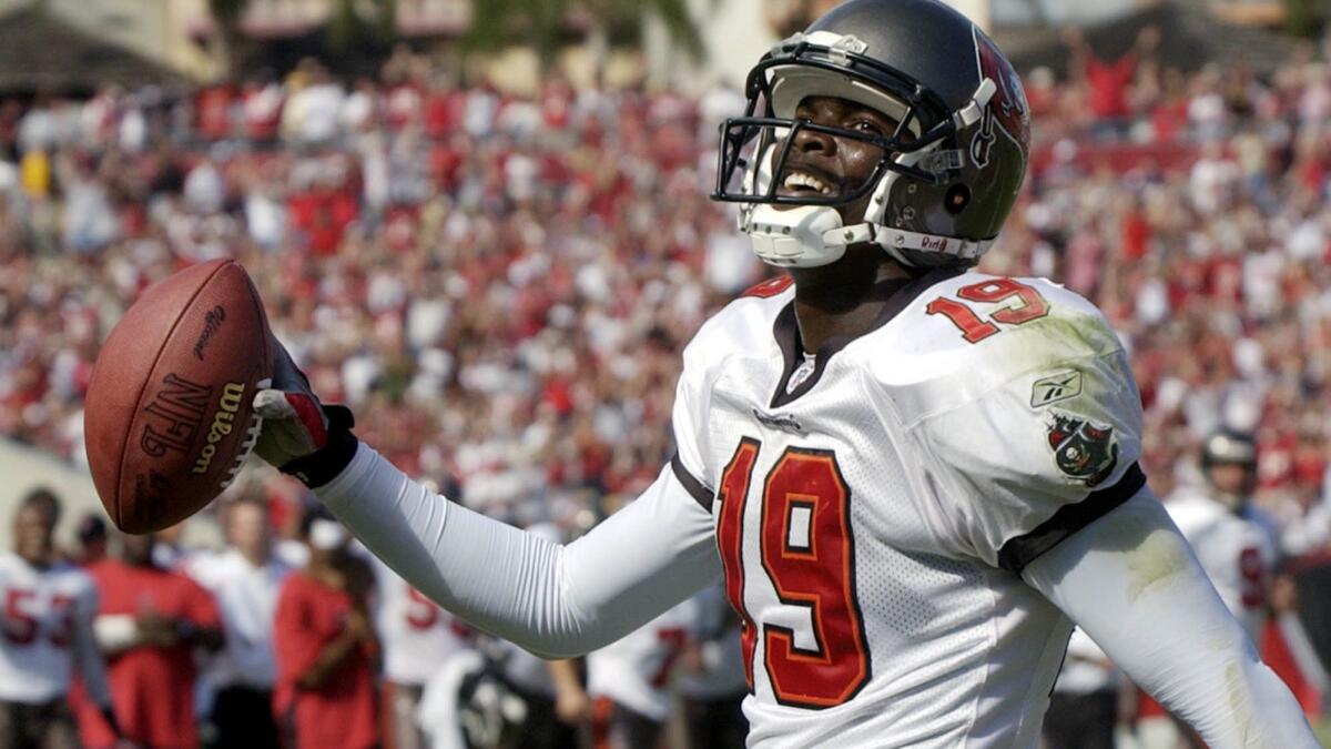 Keyshawn Johnson smiles at the end zone crowd after catching a touchdown pass in 2002. In 2017, California demanded $2.2 million in taxes for the six years the former wide receiver said he was living out of state.