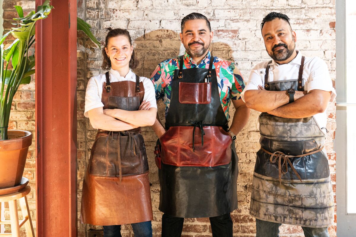 Three chefs standing for a portrait. 