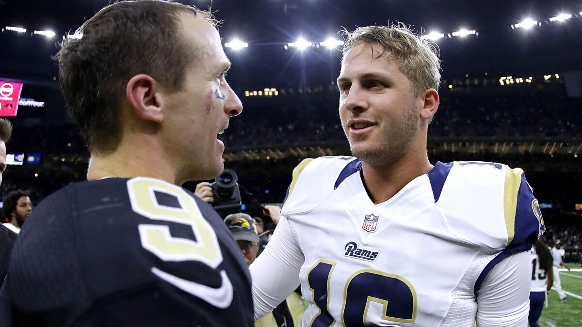 Rams rookie Jared Goff talks to Saints star Drew Brees (9) after their game last week in New Orleans.