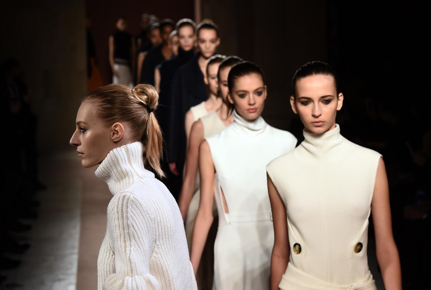 Models present creations by designer Victoria Beckham during the Mercedes-Benz Fashion Week Fall 2015 in New York on Feb. 15, 2015.