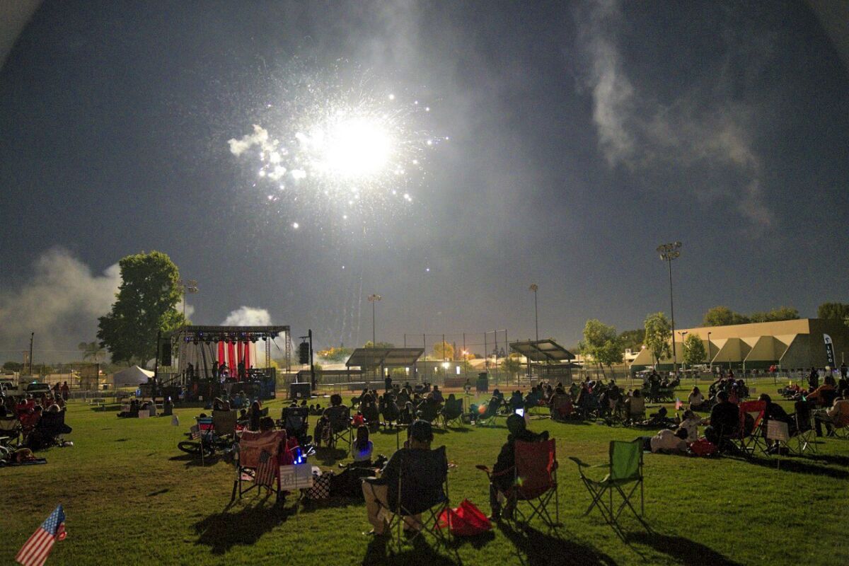 Visitors watch the fireworks show at Los Nietos Park on Independence Day eve.
