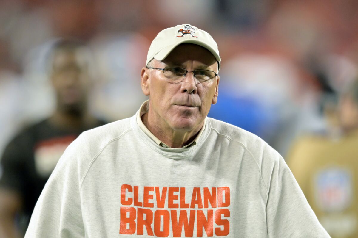FILE - In this Aug. 29, 2019, file photo, Cleveland Browns general manager John Dorsey walks on the field after an NFL preseason football game between the Detroit Lions, in Cleveland. It doesn’t take Andy Reid long when he pops on film of the Browns for the head coach of the Chiefs to see the unmistakable thumbprint of former general manager John Dorsey in their style and personnel. Probably because Reid still sees it on his own team, too. (AP Photo/David Richard, File)