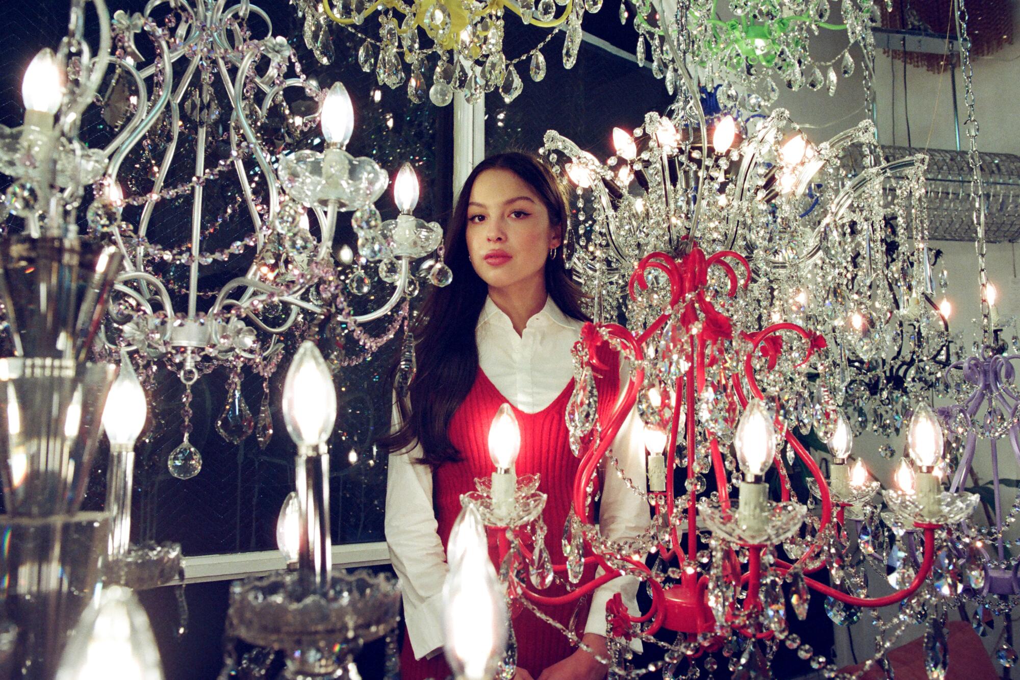 Olivia Rodrigo photographed amid chandeliers