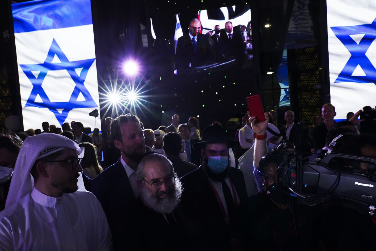 Jewish and Arab attendees celebrate the opening of the Israeli pavilion at Expo 2020 in Dubai, United Arab Emirates, Thursday, Oct. 7, 2021. Israel ceremonially opened its gleaming pavilion at the world's fair in Dubai on Thursday, over a year after normalizing ties with the United Arab Emirates and amid a pandemic that has disrupted much of the tourist and cultural exchanges promised by the U.S.-brokered accords. (AP Photo/Jon Gambrell)