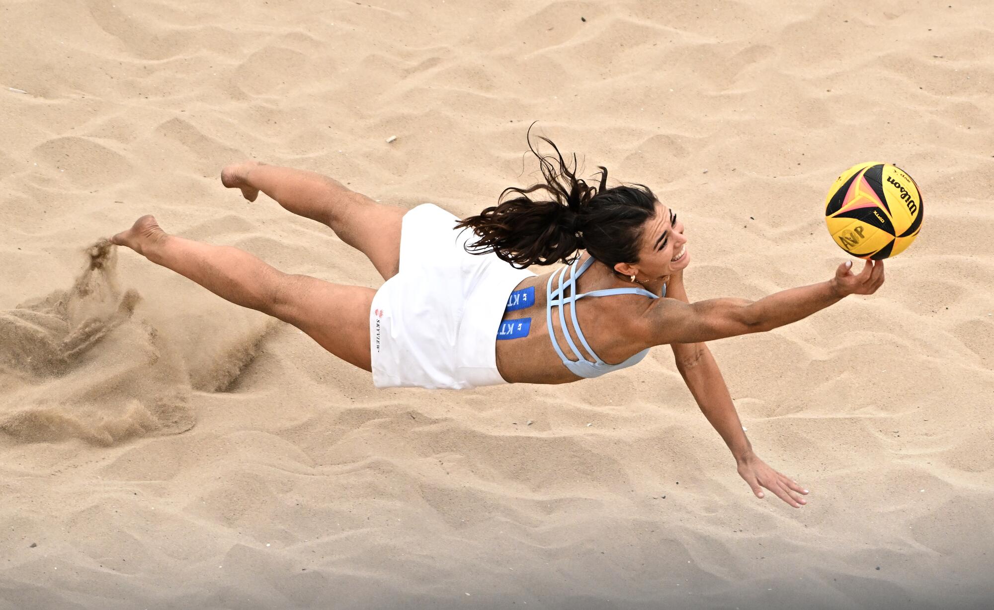 Zano Muno dives for a ball during a quarterfinal match.