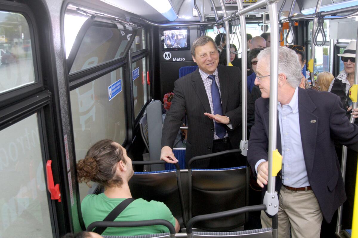 Glendale councilman/Metro board member Ara Najarian, center, talks with bus rider Steven Scaffidi, left, and L.A. City councilmember/Metro board member Paul Krekorian, right, at the start of the Metro's new NoHo to Pasadena Express Line 501 in North Hollywood, on Thursday, April 14, 2016.