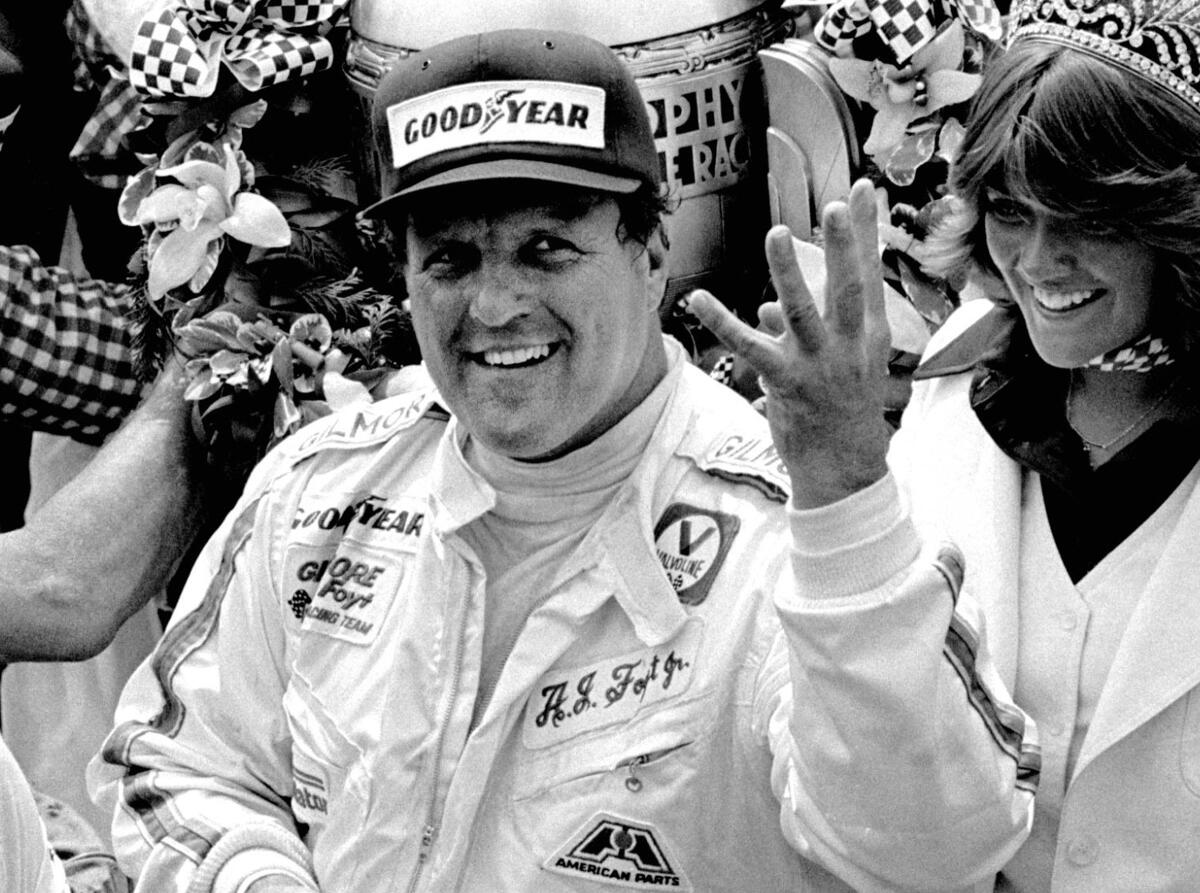 A.J. Foyt holds up four fingers in Victory Lane after winning his fourth Indianapolis 500 on May 29, 1977.