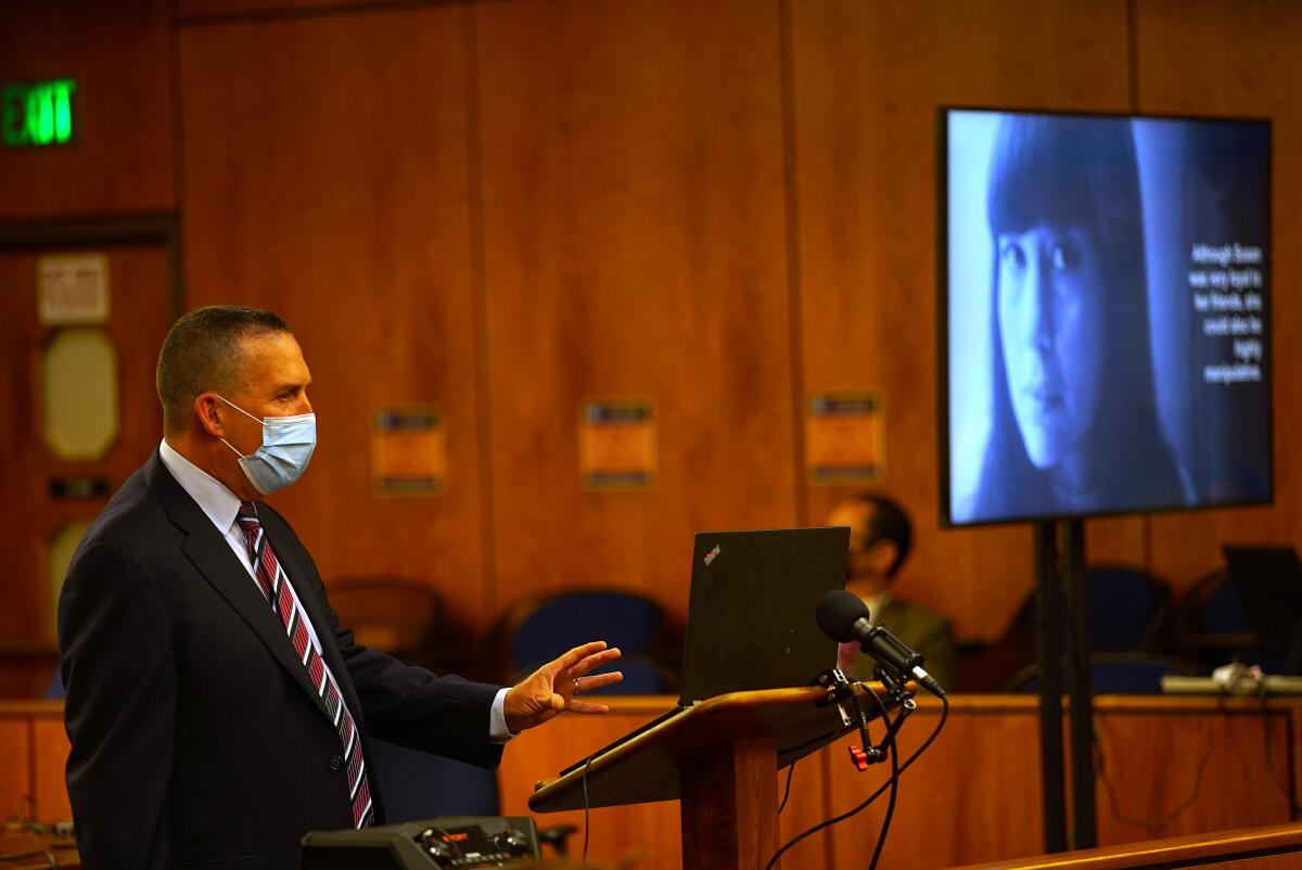 A prosecutor speaks in court while wearing a mask