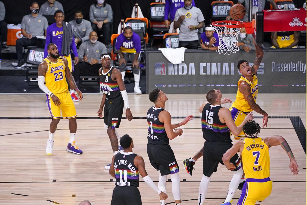 Lakers forward Kyle Kuzma scores against the Nuggets during Game 4.