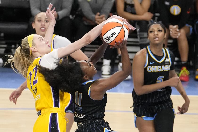 Los Angeles Sparks' Cameron Brink (22) blocks the shot of Chicago Sky's Dana Evans during the second half of a WNBA basketball game Thursday, May 30, 2024, in Chicago. (AP Photo/Charles Rex Arbogast)