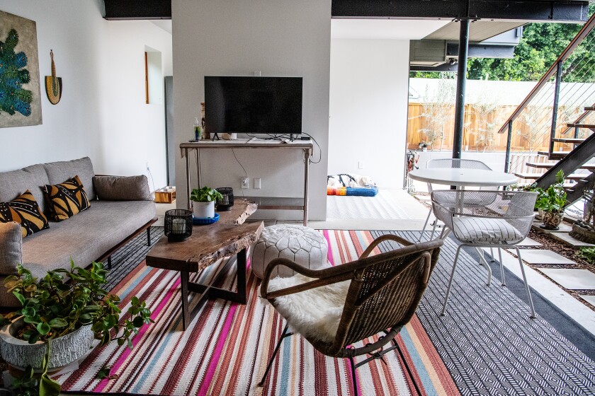 The outdoor area of Gail Otter's ADU includes a TV, sofa and chairs. 