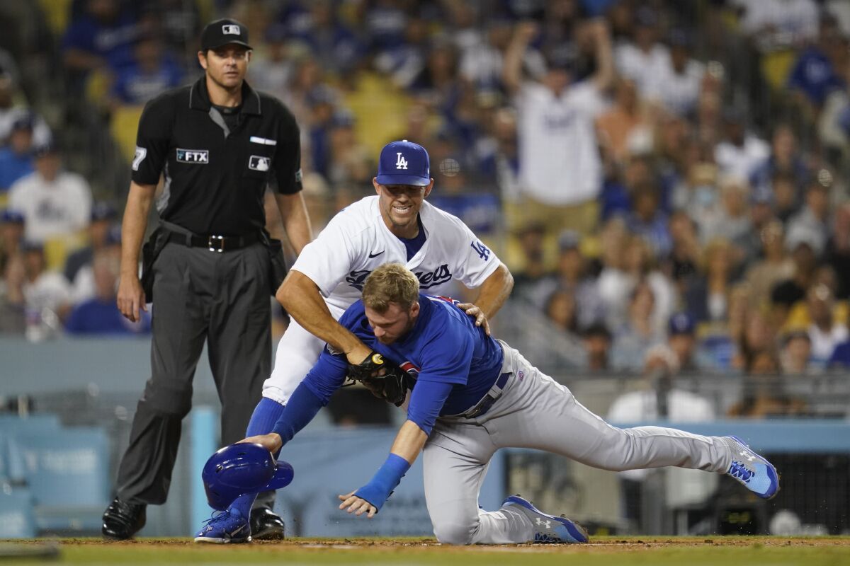Dodgers pitcher Tyler Anderson tags Chicago Cubs outfielder Ian Happ during a game on July 8, 2022, at Dodger Stadium.