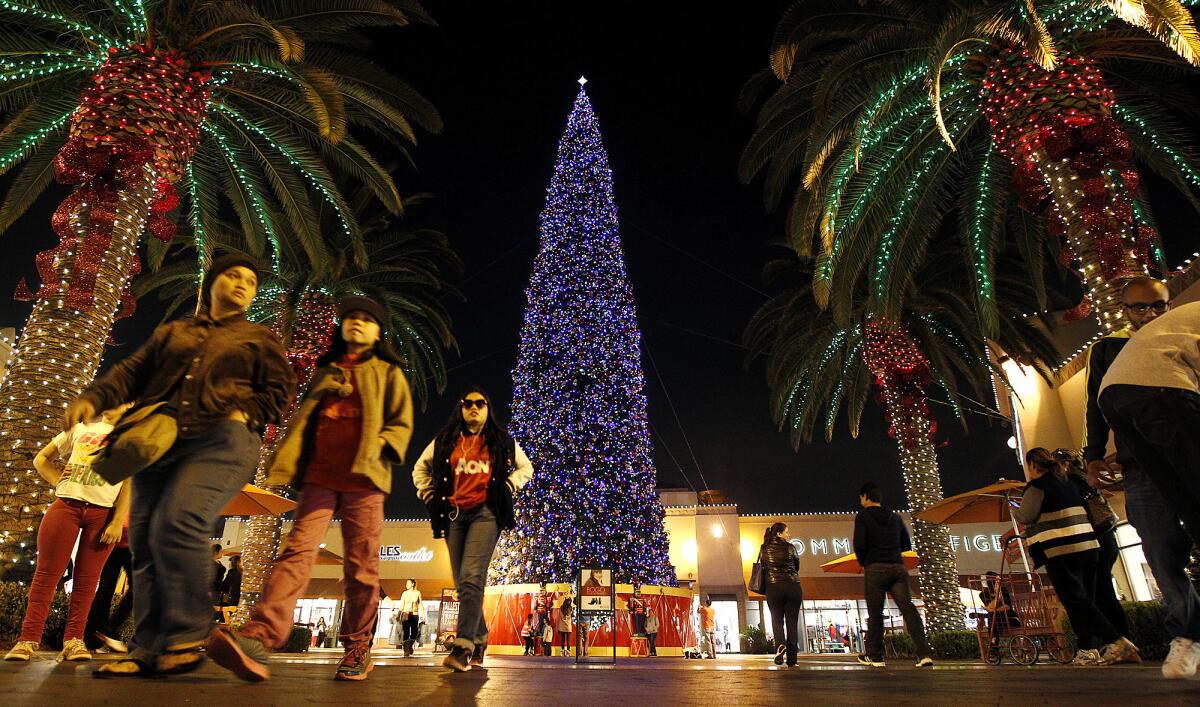 File photo of shoppers passing by a huge Christmas tree at the Citadel Mall in Los Angeles in 2013.