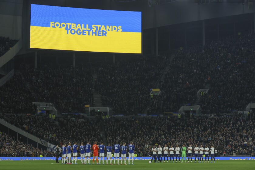 Players stand in support of Ukraine ahead of the English Premier League soccer match between Tottenham Hotspur and Everton at Tottenham Hotspur Stadium in London, Monday, March 7, 2022. (AP Photo/Ian Walton)