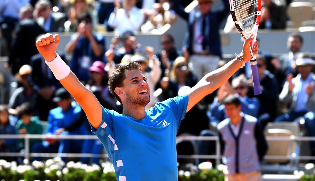 Dominic Thiem celebrates after defeating Novak Djokovic in a French Open semifinal that was suspended Friday and completed Saturday at Roland Garros.
