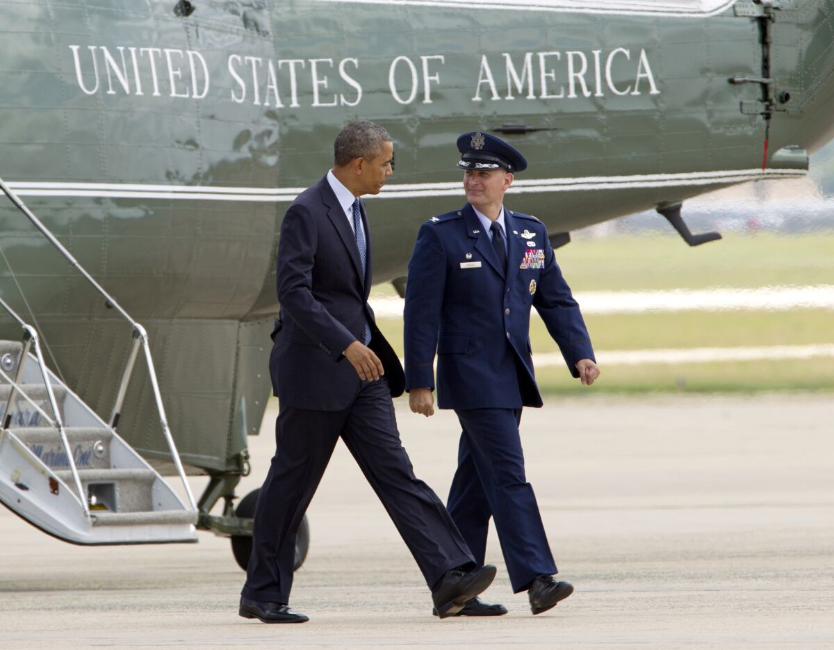 President Obama, accompanied by Col. William M. Knight, commander of the 11th Wing, walks toward Air Force One before departing Thursday from Andrews Air Force Base, Md., on a two-day trip to Minnesota.