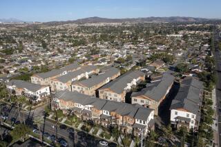 Yorba Linda, CA - November 24: An aerial view of the Heritage Crossings 3-story condo and apartment buildings at center of photo, built in 2016, amidst a community mostly consisting of single-story, single family houses on Wednesday, Nov. 24, 2021. Orange County cities are pushing back against state requirements for regions to build more dense housing projects. (Allen J. Schaben / Los Angeles Times)