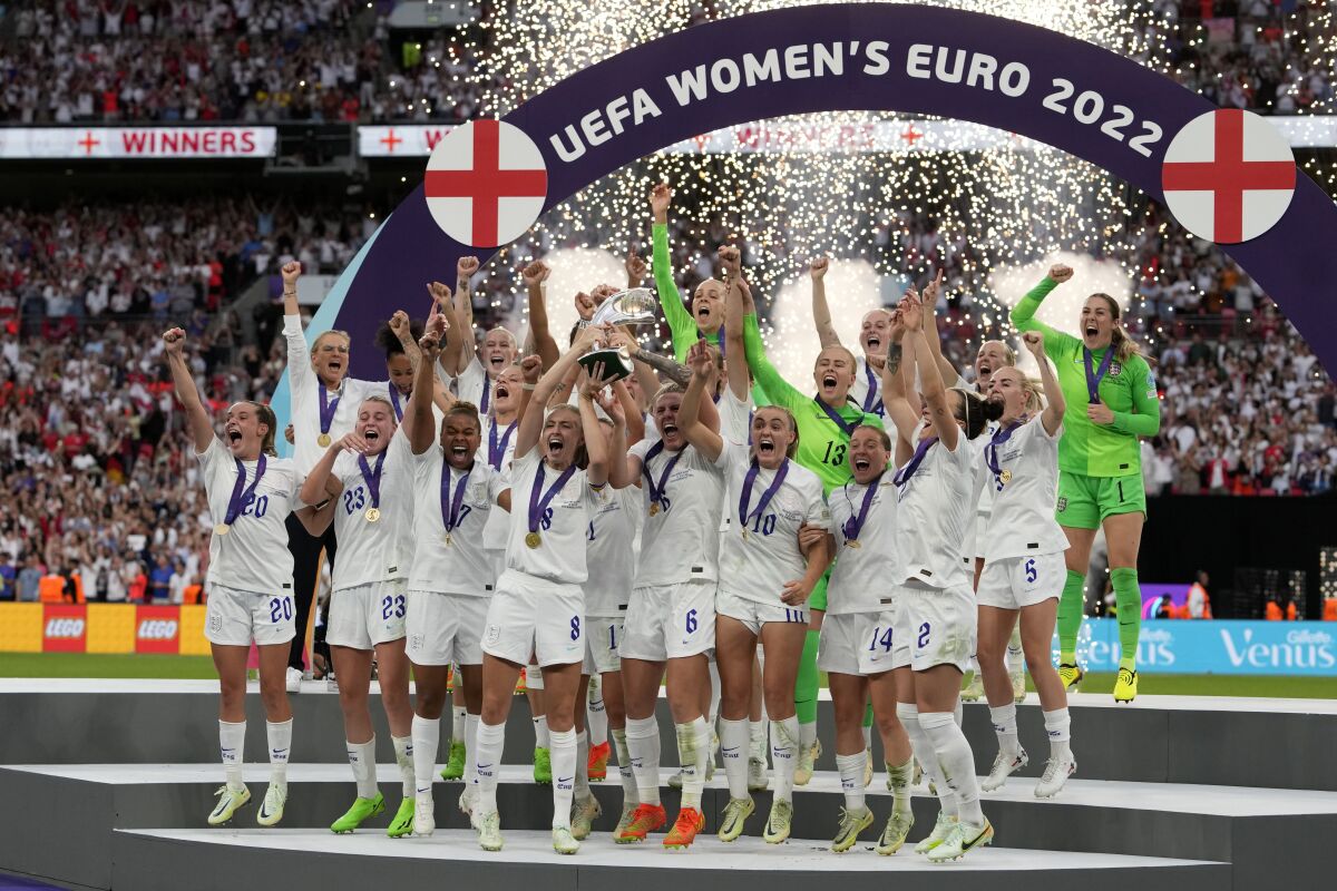 FILE - England's Leah Williamson, center left, and Millie Bright lift the trophy after winning the Women's Euro 2022 final soccer match between England and Germany at Wembley stadium in London, Sunday, July 31, 2022. England won 2-1. (AP Photo/Alessandra Tarantino, File)