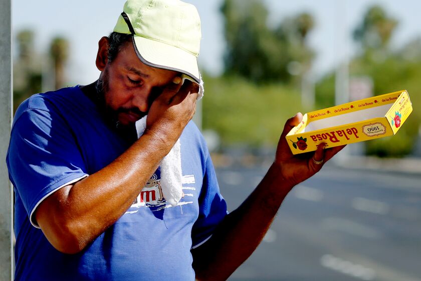 MEXICALI, CA-AUGUST 27, 2019: Oswaldo Ortiz wipes his face from sweat while selling Mazapan, a candy, on August 26, 2019 in Mexicali, Mexico. He and his family are hoping to gain asylum in the United States from Guatemala. Under the unprecedented “Remain in Mexico” policy, Trump Homeland Security officials have forced a record 35,000 asylum seekers back to Mexico in less than seven months, to wait for their U.S cases in some of the world’s most dangerous cities. (Photo By Dania Maxwell / Los Angeles Times)