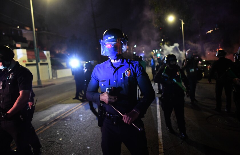 LAPD's move to close Echo Park homeless encampment met with
protests, clashes 7 Police on guard on Glendale Avenue during protest at Echo Park.