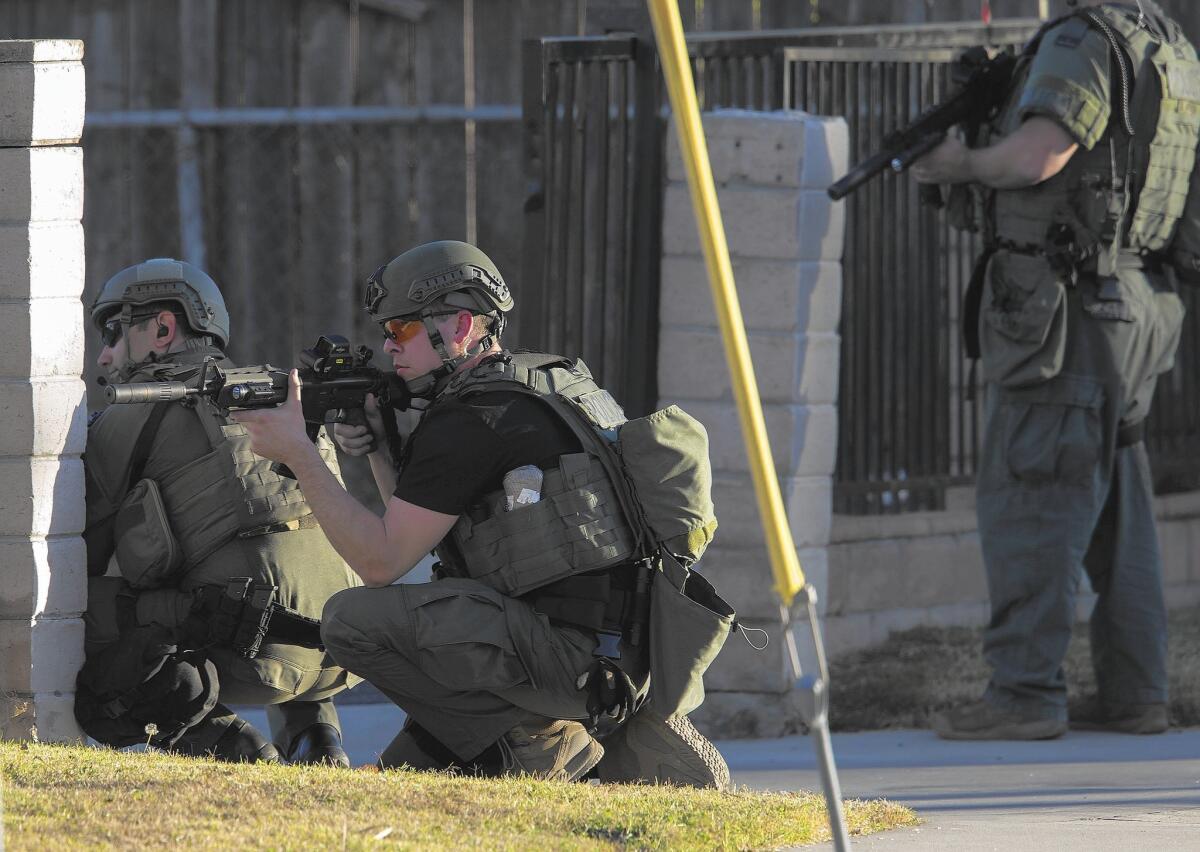There has been a threefold rise in mass shootings in the U.S. since 2011, a study found. Above, SWAT officers surround a home while searching for suspects in the mass shooting in San Bernardino.