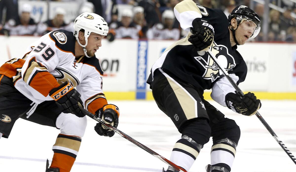 Ducks left wing Matt Beleskey gives chase against Penguins left wing Blake Comeau during the season-opening game Thursday in Pittsburgh.