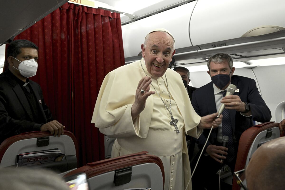 Pope Francis greets the journalists onboard the papal plane during the flight back to Rome at the end of his two-day apostolic visit to Malta, Sunday, April 3, 2022. (Ciro Fusco /Pool photo via AP)