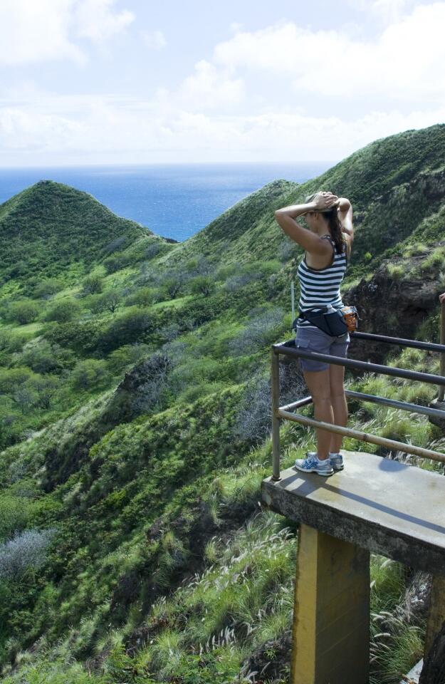 A hiker enjoys the view from a lookout on Diamond Head.