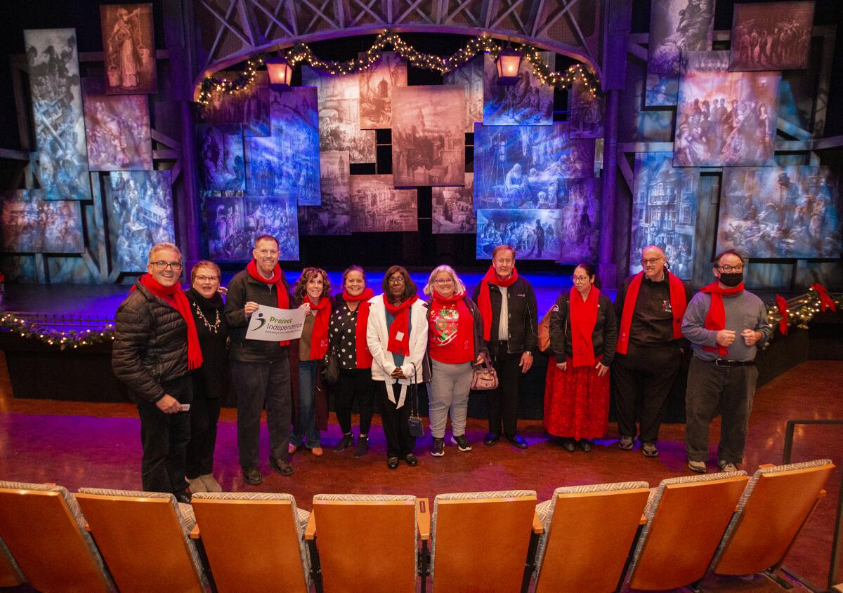 Todd Eckert and Paul Tomei with Project Independence clients Friday at a South Coast Repertory's of "A Christmas Carol."