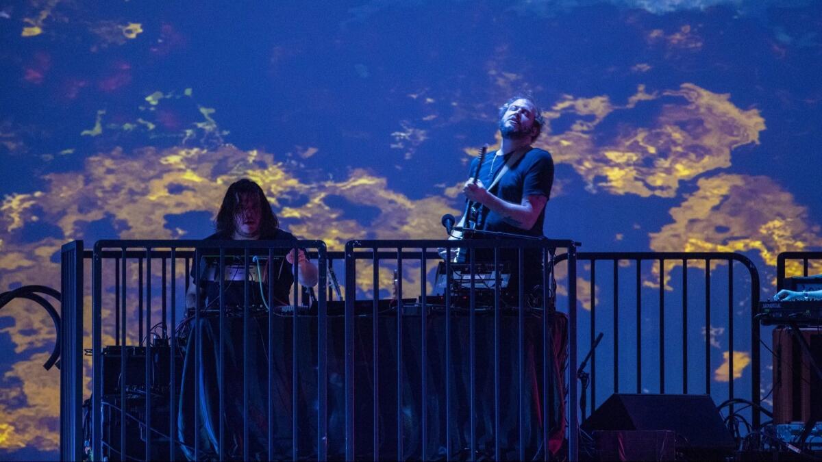 Justin Vernon, right, and his bandmates occupied an elevated platform at the rear of the stage.