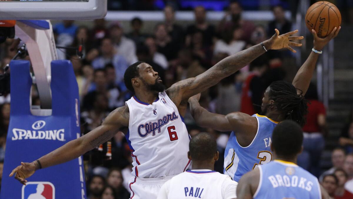 Clippers center DeAndre Jordan tries to block a shot by Denver Nuggets forward Kenneth Faried during a game at Staples Center in April.