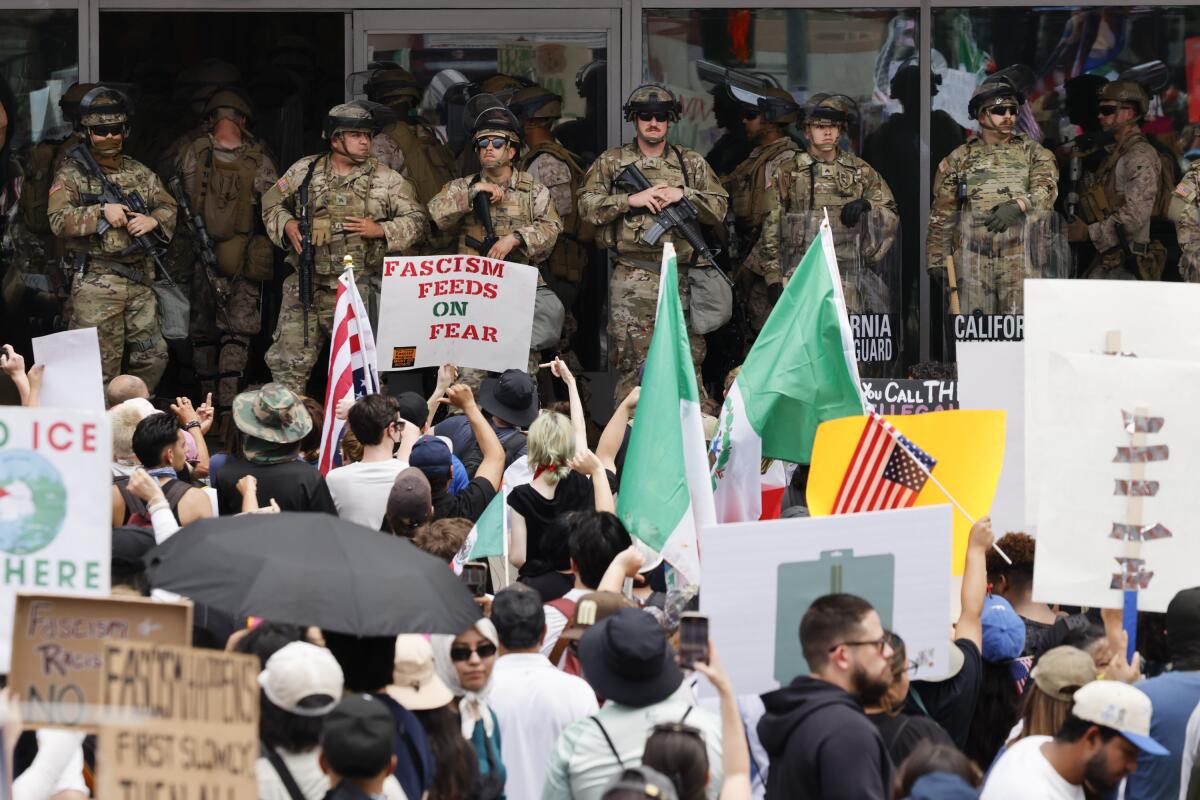 The National Guard stands in front of the federal building during "No Kings Day" in downtown Los Angeles