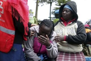 Kenya Red Cross personnel and relatives try to comfort a woman reacting near a burned-out dormitory, following a fire at the Hillside Endarasha Primary in Nyeri, Kenya Friday, Sep. 6, 2024. (AP Photo)