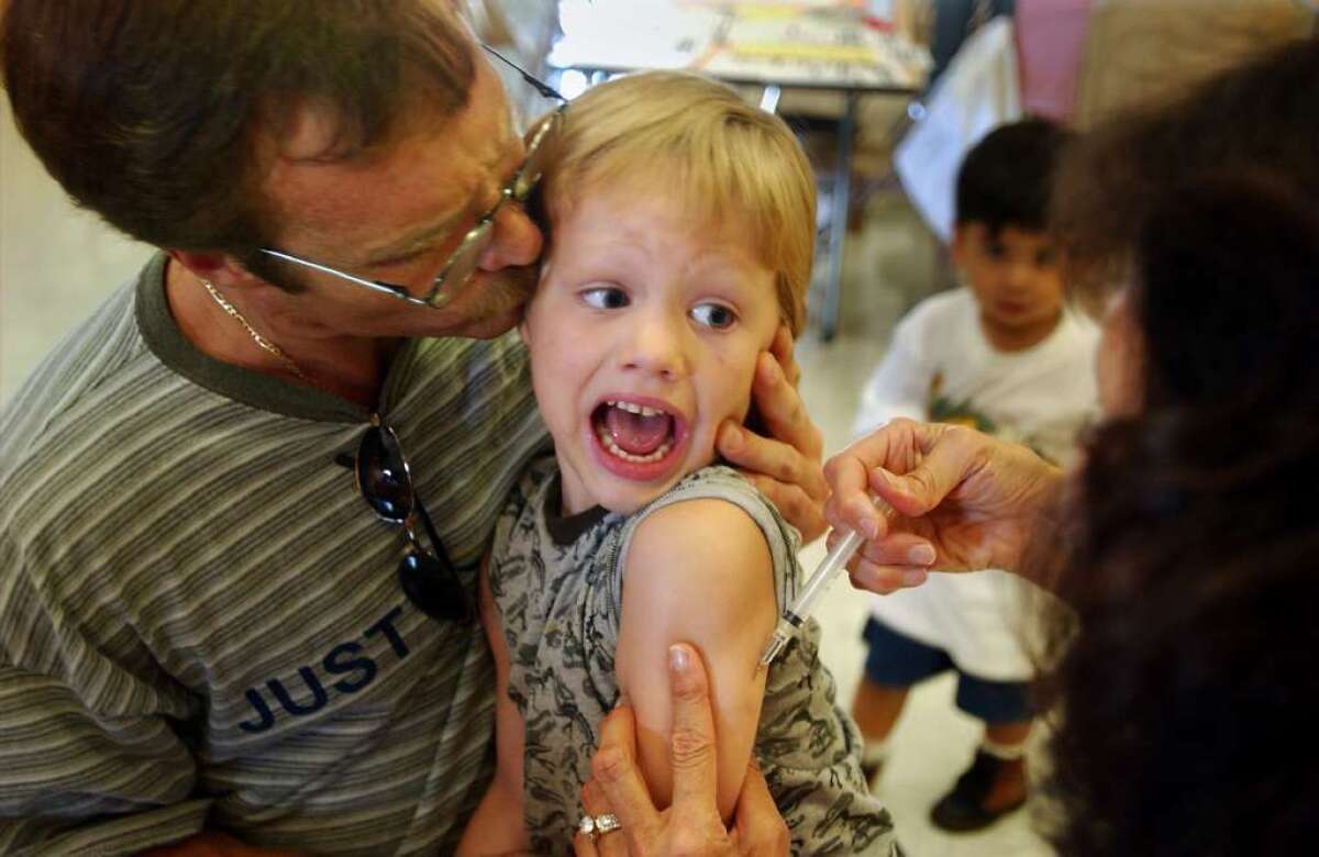 An incoming kindergarten student gets his measles, mumps and rubella shot in this file photo. State officials are reporting increases in measles cases.