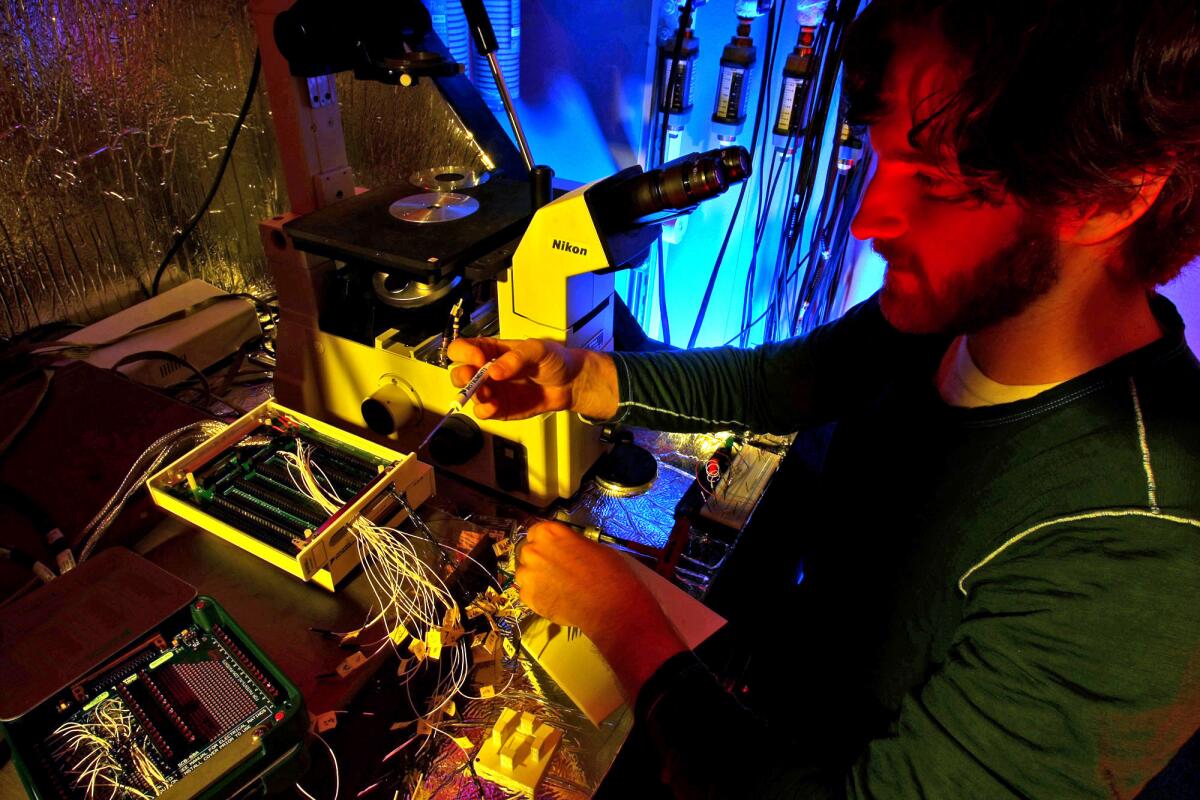 Henry Sillin, a fourth-year graduate student in physical chemistry at UCLA, sits at the "Faraday cage," which is part of the equipment used to test the chip. "We should have walked away," Sillin says, "but it never failed enough for us to give up."