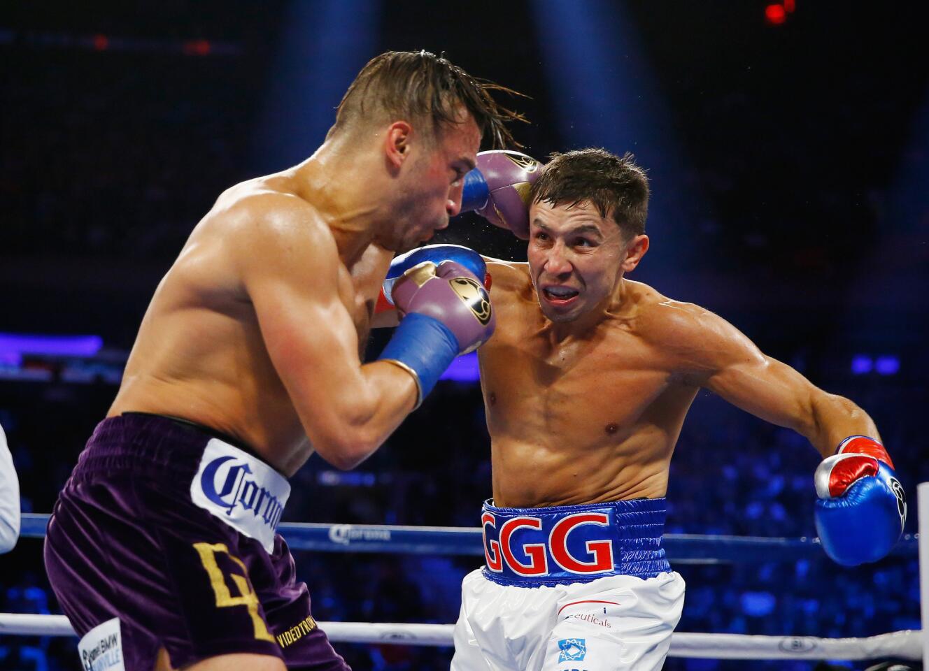 David Lemieux, left, and Gennady Golovkin trade punches in the middle of the ring during their middleweight title fight Saturday night in New York.