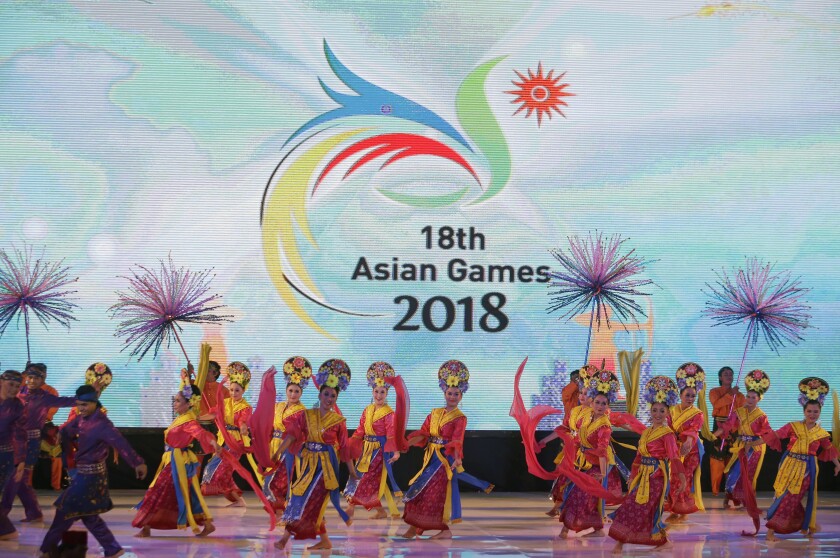 FILE - Traditional dancers perform during the unveiling of the logo of the 18th Asian Games in Jakarta, Indonesia on Sept. 9, 2015. Less than three months after Beijing hosted the Winter Olympics and Paralympics, reports in China on Friday, May 6, 2022 said this year's Asian Games are being postponed because of concerns over the spreading omicron variant of COVID-19 in the country. (AP Photo/Tatan Syuflana, File)