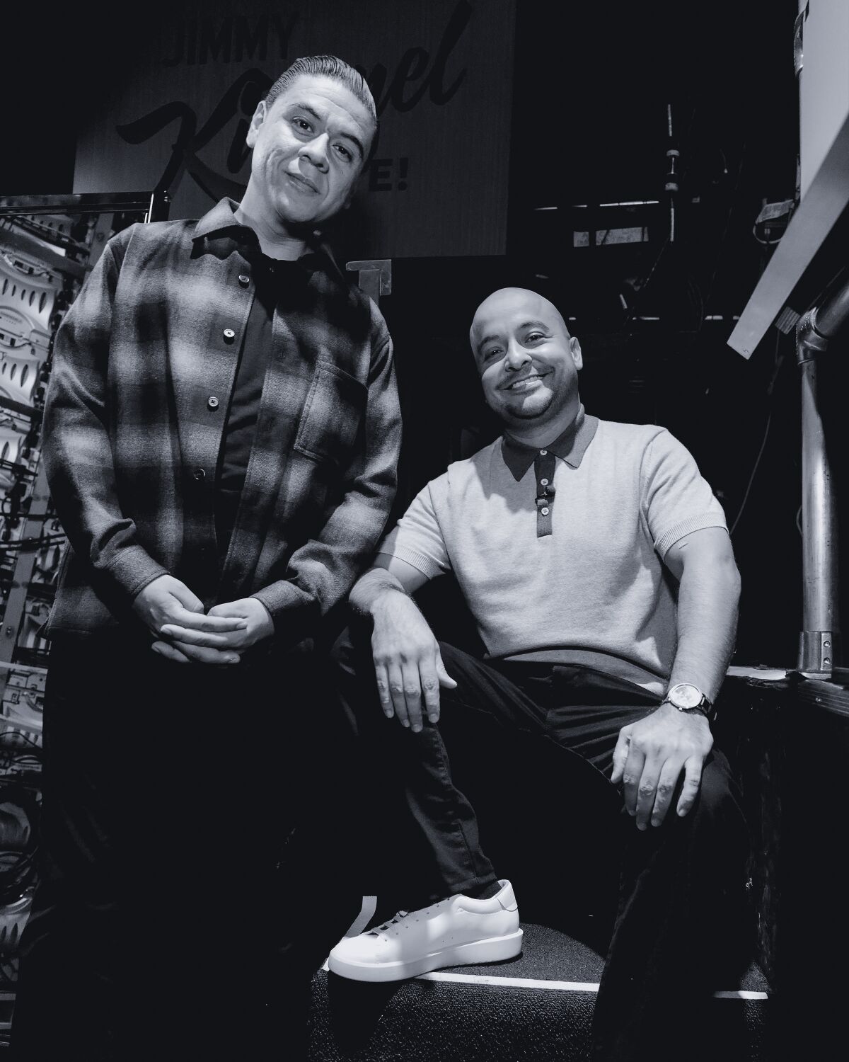 Two guys, one standing and one sitting