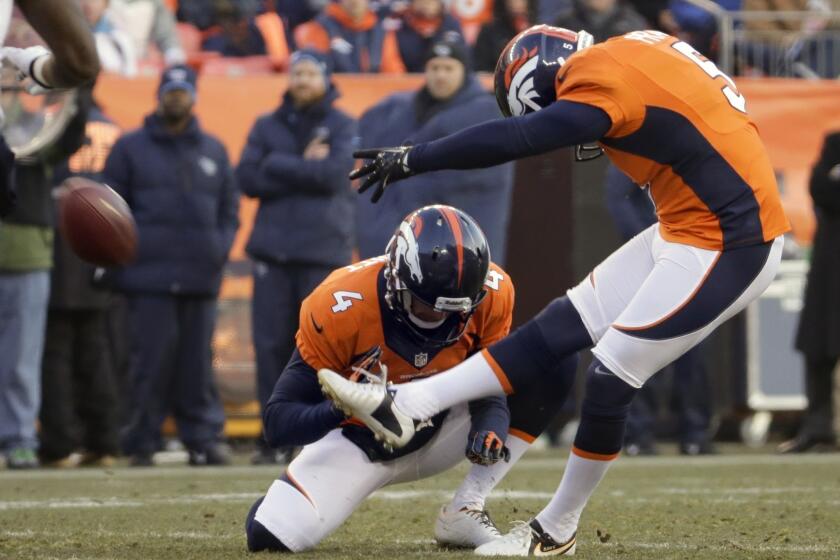 Matt Prater of the Denver Broncos kicks an NFL-record 64-yard field goal out of a hold by Britton Colquitt with three seconds left in the first half of Sunday's game against the Tennessee Titans.